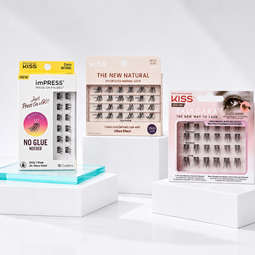 A variety of Kiss lash products displayed on white plinths against a white backdrop.