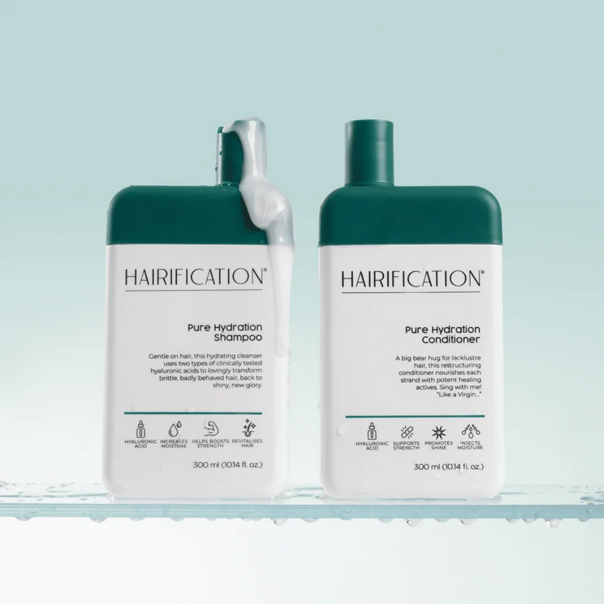 Hairification Pure Hydration Shampoo & Conditioner Bundle showcased on glass shelves with water-inspired droplets against a soft green background.