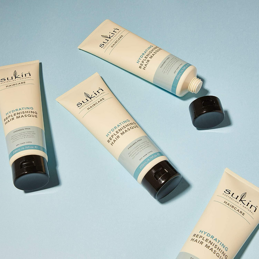 Sukin Haircare Hydrating Replenishing Hair Masques displayed against a soft blue backdrop.