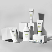 ZEROID skincare products displayed on white plinths against a grey backdrop with soft shadows.