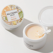 Heimish All Clean Balm displayed with an applicator on a white studio backdrop.