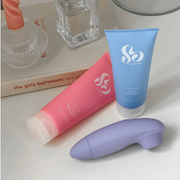 So Divine intimate care products and a purple personal care device displayed on a bathroom vanity.