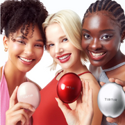 Women holding TirTir products in a white studio setting.