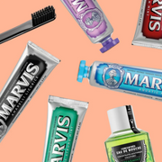 A variety of Marvis Toothpaste displayed against a soft peach backdrop.