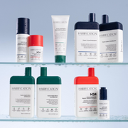 A variety of Hairification products displayed on glass shelves against a blue radiant backdrop.