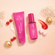 2BTanned Gradual Tan Lotion and Tanning Water displayed with berries, sweets and glossy textures against a soft peach backdrop.
