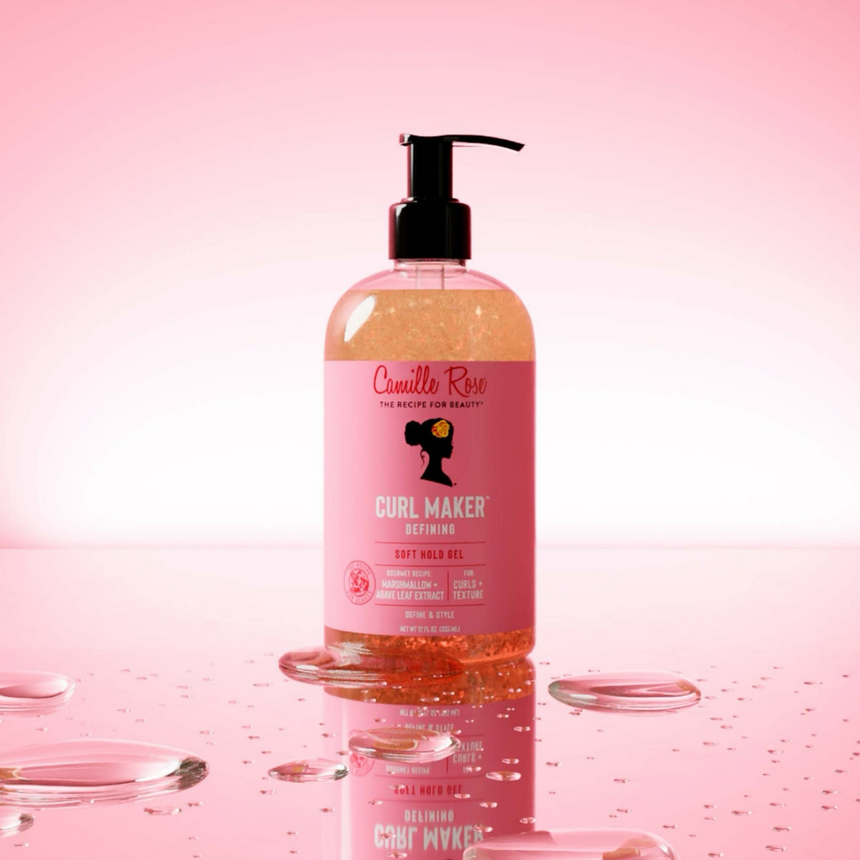 Camille Rose Curl Maker Curling Jelly displayed with water-inspired droplets against a soft pink radiant backdrop.