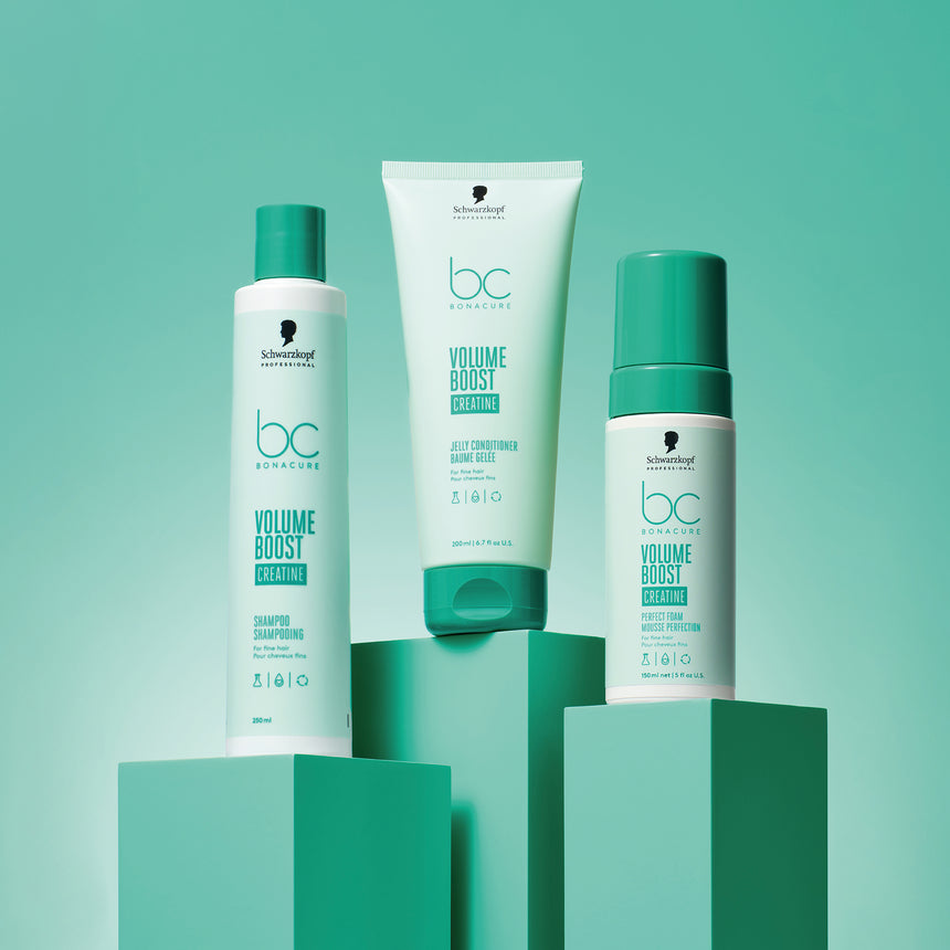 Schwarzkopf Professional Volume Boost products featuring Shampoo, Conditioner and Perfect Foam displayed on a green backdrop.