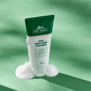 VT Cosmetics Cica Mild Foam Cleanser displayed with creamy product swatches against a green display.