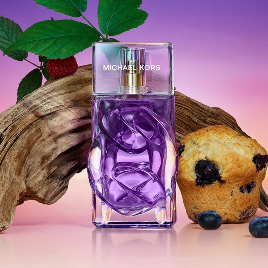 New In Michael Kors fragrance surrounded by scent-inspired elements.