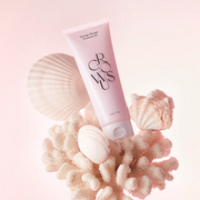 GROWUS Damage Therapy Hair Cream Treatment tube displayed among coral and seashells against a soft pink background.
