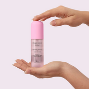 Hands holding Gem Body & Hair Fragrance Mist Coconut Vanilla against a white backdrop.