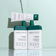 Hairification products displayed with water-inspired droplets against a soft green backdrop.