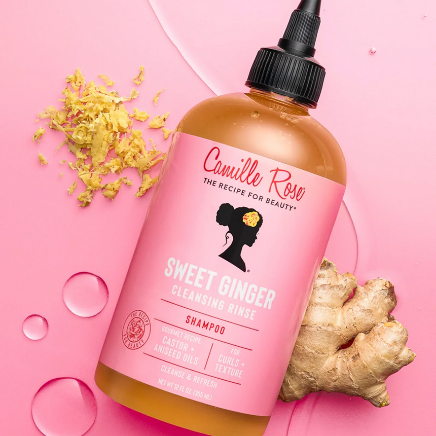 Camille Rose Sweet Ginger Cleansing Rinse displayed with product-inspired elements against a radiant pink backdrop.