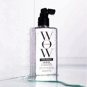 Color Wow Extra Strength Dream Coat displayed with water droplets against a clean white background.