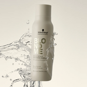 Schwarzkopf Professional Bond Repair Nourishing Conditioner displayed on a light background with water-inspired droplets.