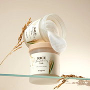SkinFood Rice Brightening Pads displayed on a glass shelf against a beige backdrop.