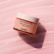 Heimish Watermelon Moisture Soothing Gel Cream displayed against a creamy pink skincare texture.