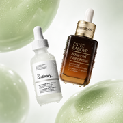 The Ordinary Niacinamide 10% + Zinc 1% and Estée Lauder Advanced Night Repair Serum displayed amongst dewy green gel textures on a clean white backdrop.