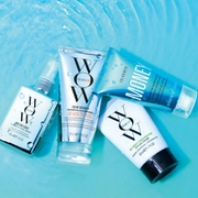 A selection of Color Wow styling and haircare products displayed against a bright aqua blue background.