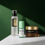 COSRX Advanced Snail 96 Mucin Power Essence, Purito Wonder Releaf Centella Serum Unscented and Medicube Deep Vita C Capsule Cream displayed against a deep green backdrop with dramatic shadows.