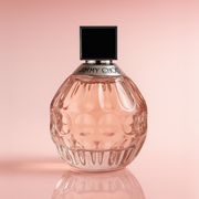 Jimmy Choo I Want Choo on a baby pink gradient background.