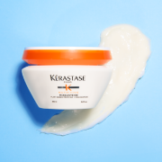 Kérastase hair mask jar displayed with a creamy product texture against a light blue background.