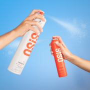 Schwarzkopf OSiS+ hair styling sprays being misted against a bright blue background.
