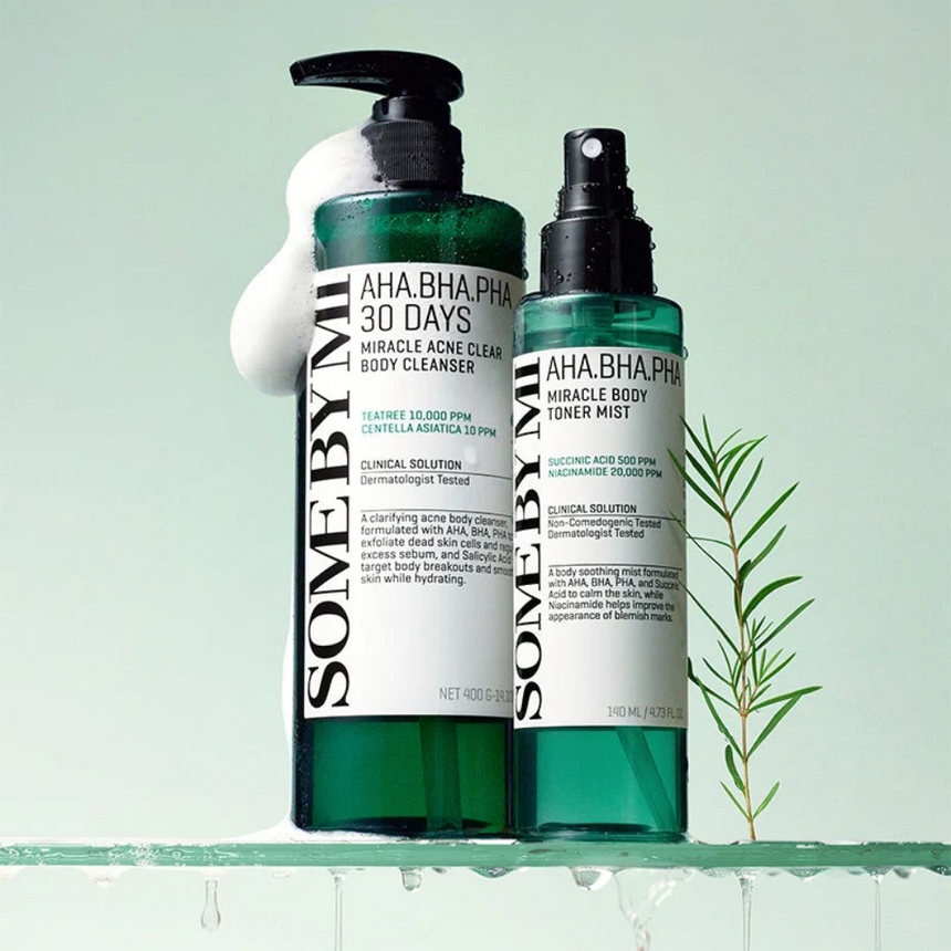 Some By Mi Miracle Ance Clear Body Cleanser and Miracle Body Toner Mist presented on a pale green background with water-inspired droplets.
