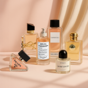 Women’s designer fragrances and perfumes on a pink background.