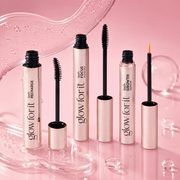 Glow For It Products featuring Lash Focus Mascara, Lash Growth Serum and Lash Recharge displayed against a glossy pink backdrop with clear, bubble-like textures. 