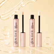 Glow For It Lash Growth Serum and Brow Growth Serum displayed on a yellow backdrop with clear, bubble-like textures.